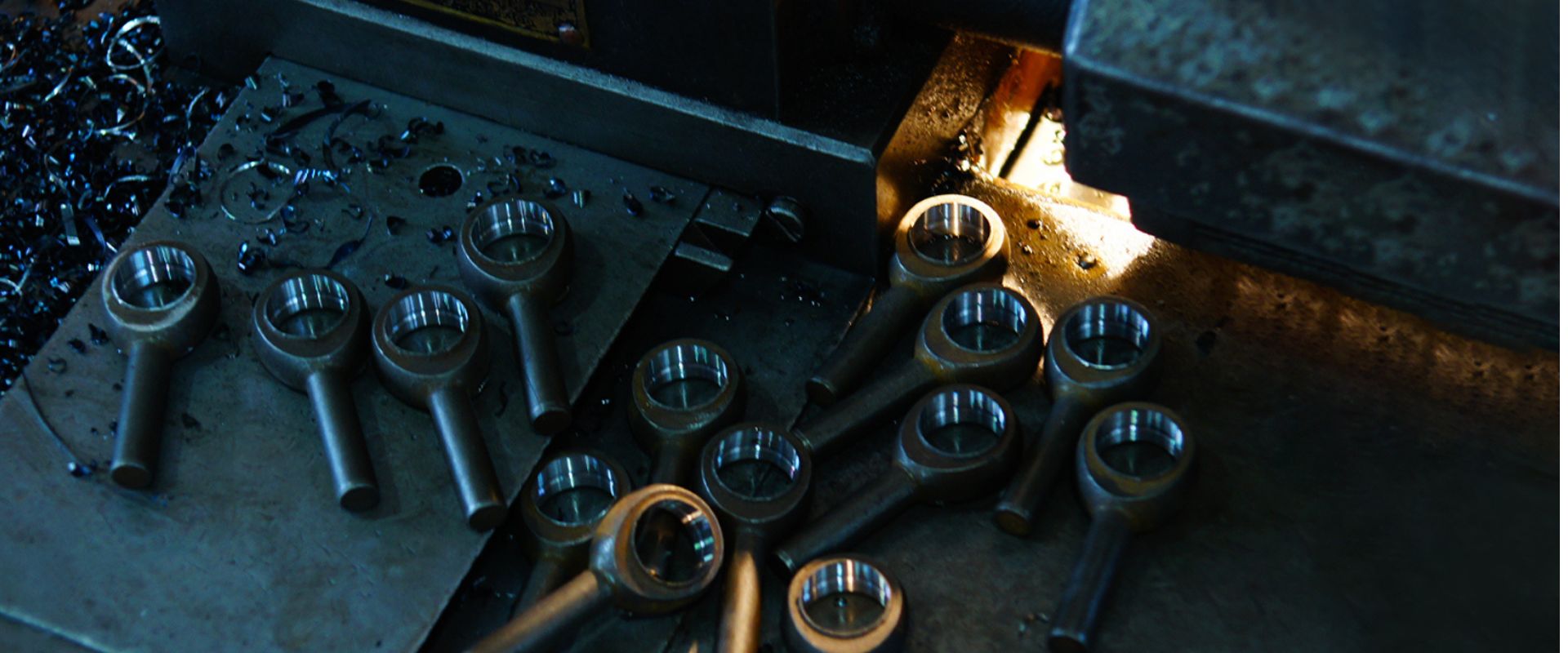 Stainless steel rod ends on a machining table at Profab Machine