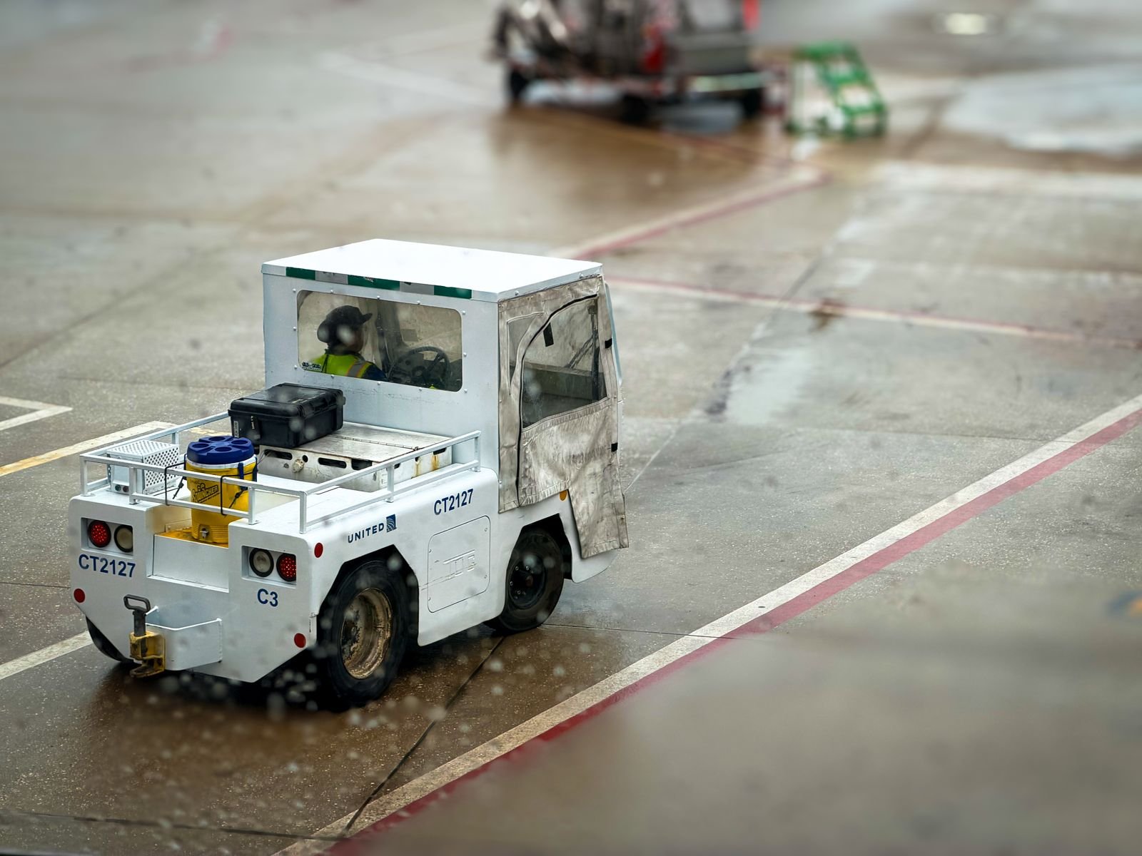 White airport tow tractor on a hangar floor