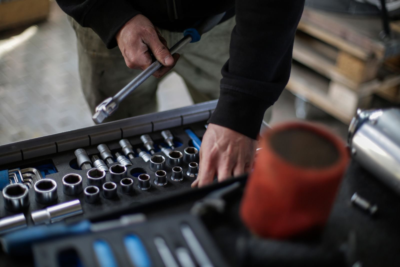 Mechanic picking a socket from a tool set