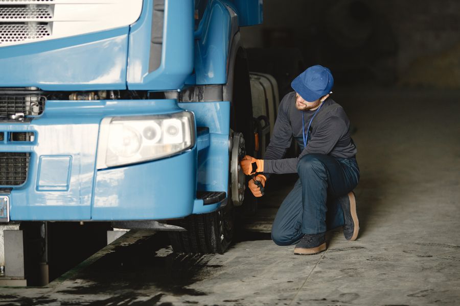 Technician servicing a truck wheel end