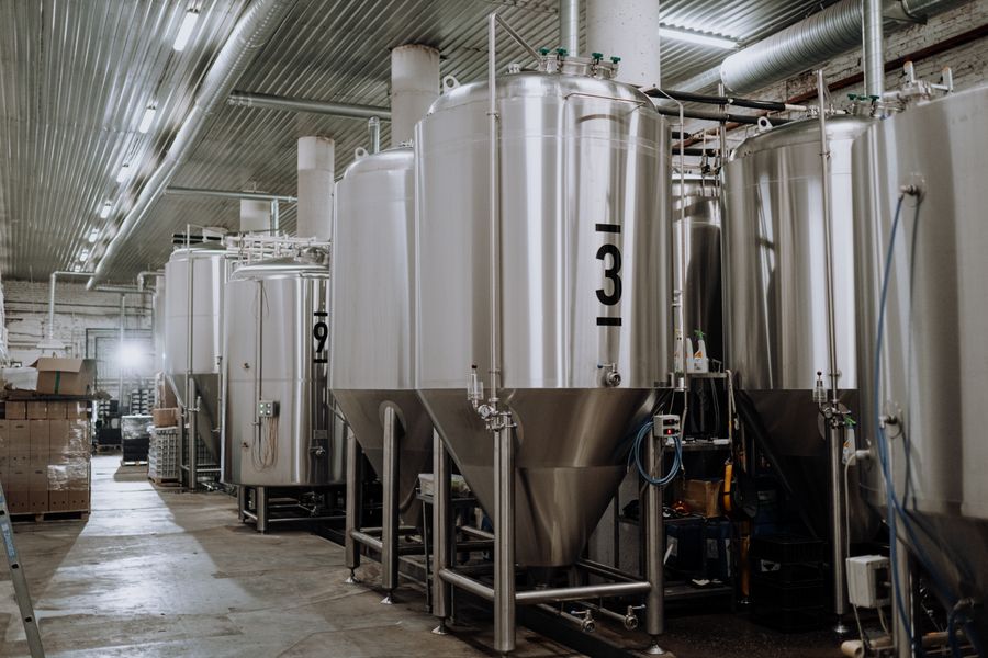 Stainless steel process tanks in a beverage plant