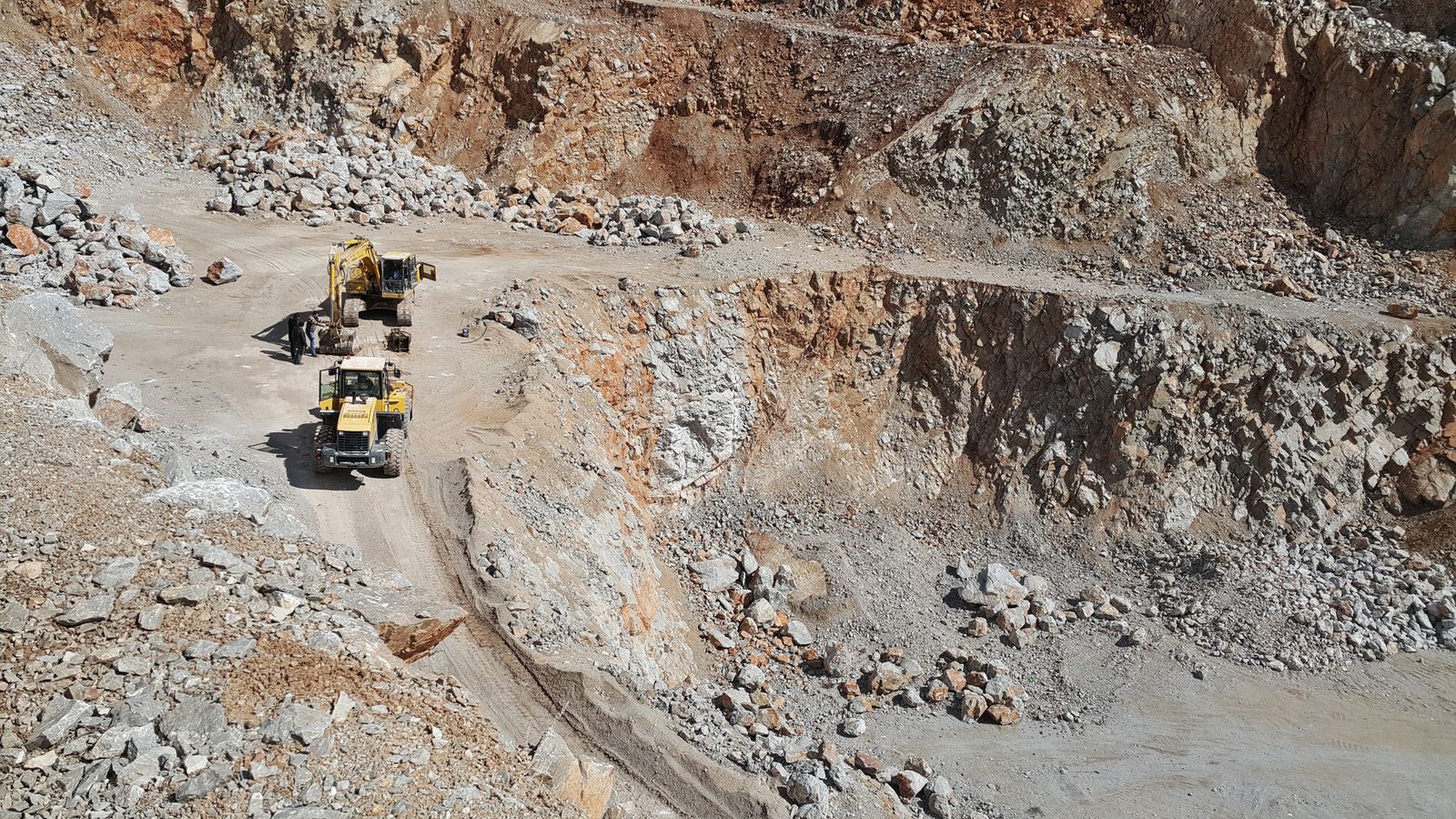 Loader and excavator working in an open pit