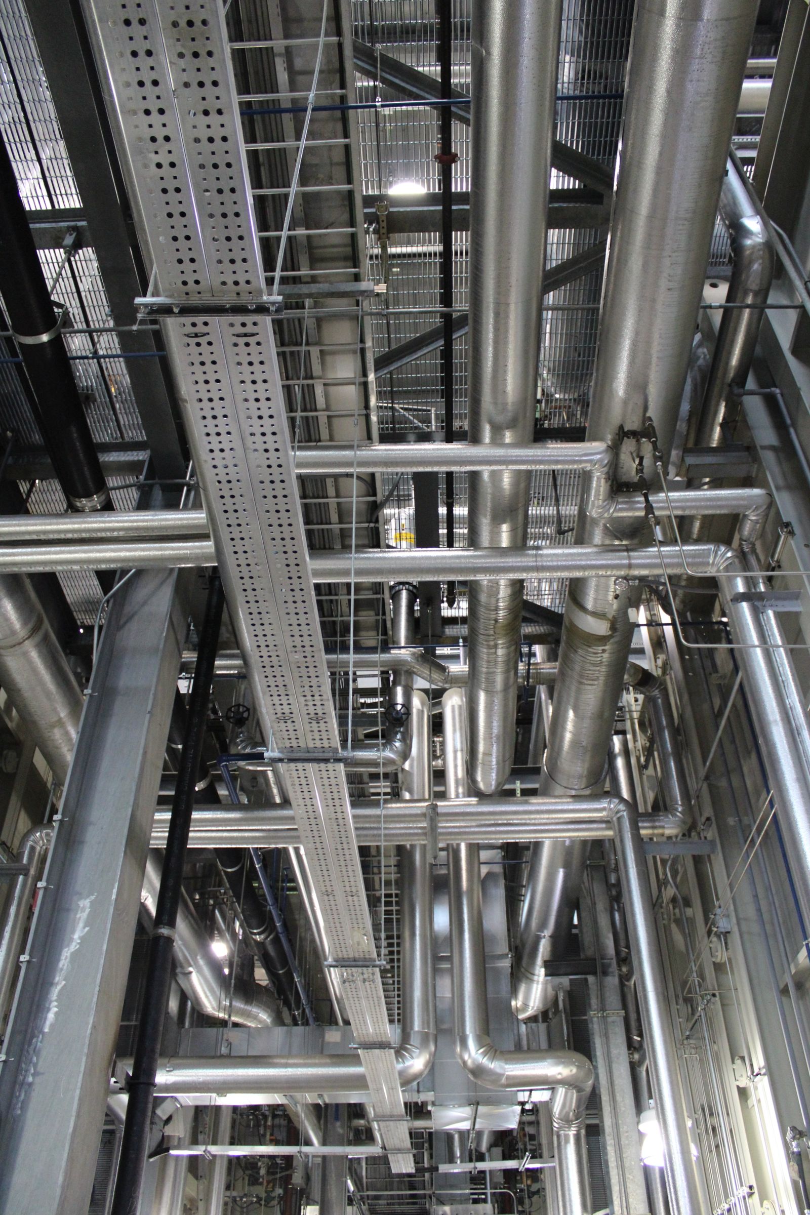 Steel pipes and cable tray supports inside a utility plant