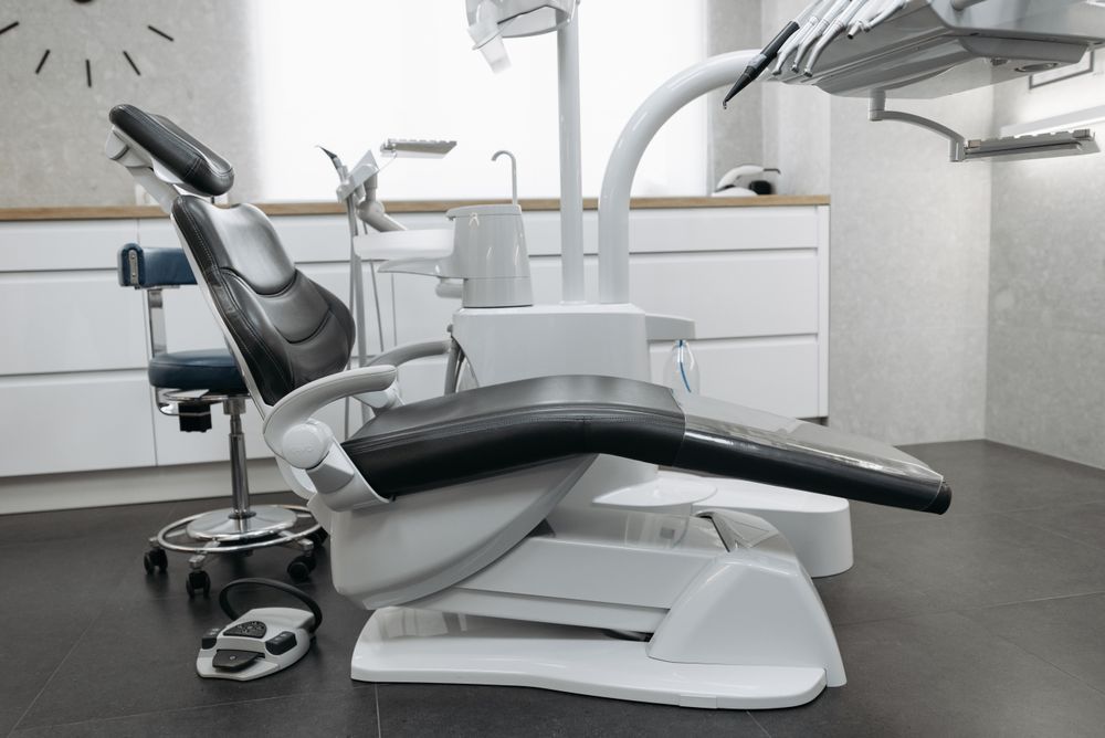 Dental chair with an articulated arm in an empty treatment room
